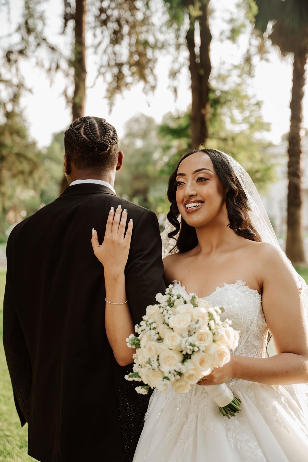Bride laughing over the groom's shoulder